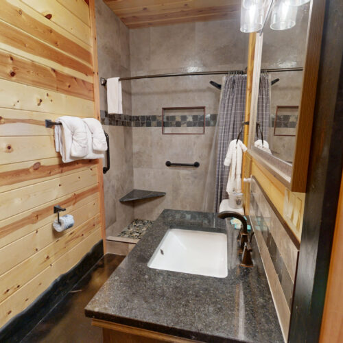 Rustic bathroom with wooden walls and modern fixtures.