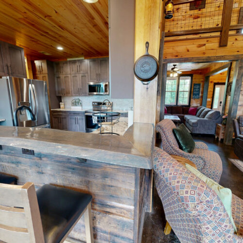 Rustic kitchen and living area with wooden accents and cozy seating.