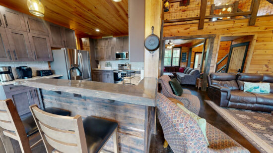 Rustic kitchen and living area with wooden accents and cozy seating.