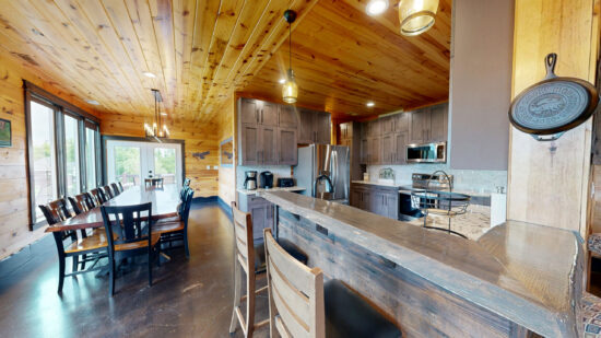 Rustic kitchen with wooden ceiling and modern appliances.