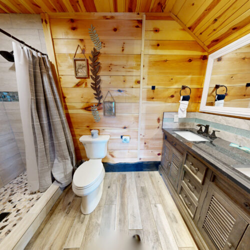 Cozy wooden bathroom with modern fixtures and rustic charm.