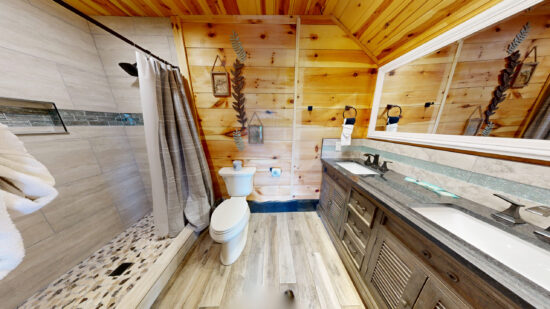 Cozy wooden bathroom with modern fixtures and rustic charm.