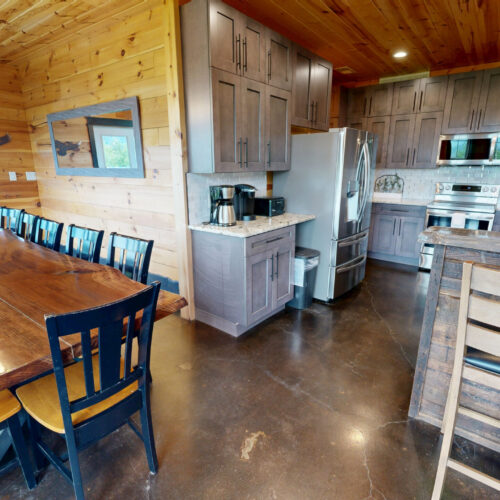 Cozy rustic kitchen and dining area with wooden accents and modern appliances.