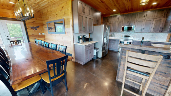 Cozy rustic kitchen and dining area with wooden accents and modern appliances.