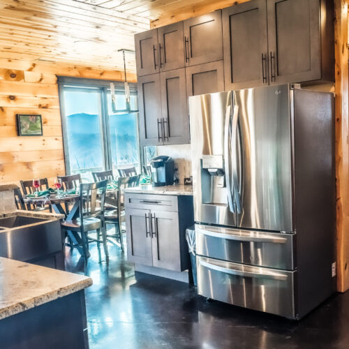 Modern kitchen with stainless steel appliances and wooden cabinets.