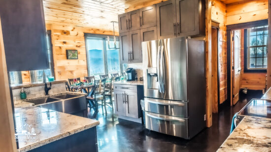 Modern kitchen with stainless steel appliances and wooden cabinets.