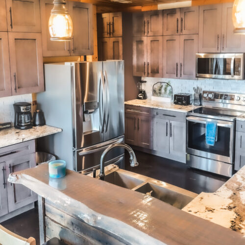 Modern kitchen with stainless steel appliances and wooden cabinetry.
