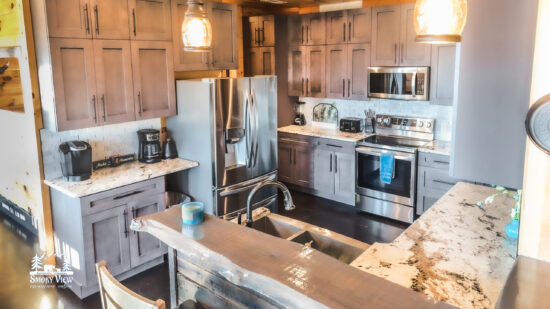 Modern kitchen with stainless steel appliances and wooden cabinetry.