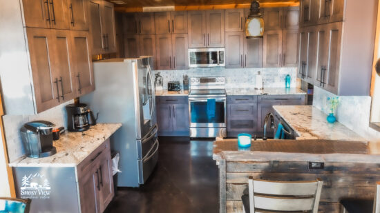 Rustic kitchen with modern appliances and wooden cabinetry.