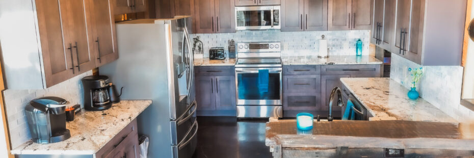 Rustic kitchen with modern appliances and wooden cabinetry.