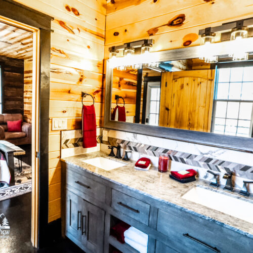 Bright rustic bathroom with wooden walls and modern fixtures.