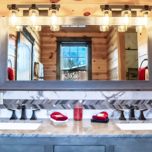 Elegant bathroom vanity with dual sinks and illuminated mirrors.