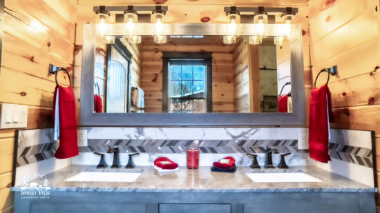 Elegant bathroom vanity with dual sinks and illuminated mirrors.