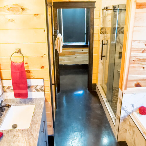 Bright rustic bathroom with wooden walls and modern fixtures.