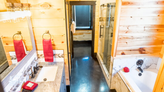 Bright rustic bathroom with wooden walls and modern fixtures.
