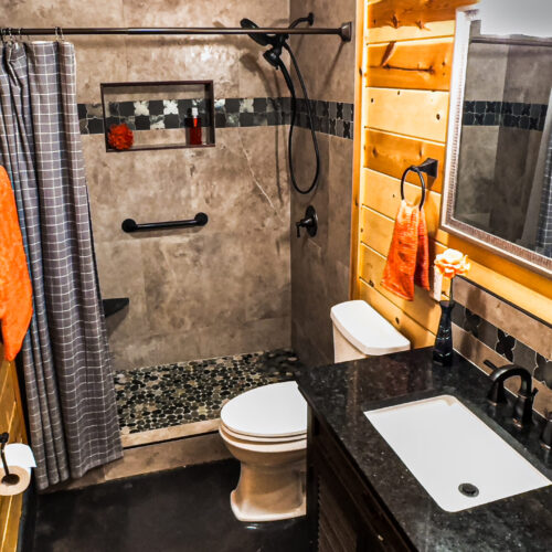 Cozy rustic bathroom with wood accents and a walk-in shower.