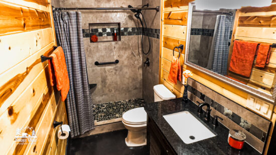 Cozy rustic bathroom with wood accents and a walk-in shower.