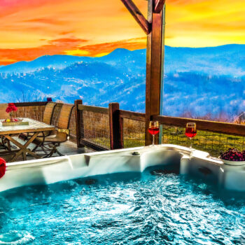 Relaxing hot tub overlooking scenic mountains at sunset.