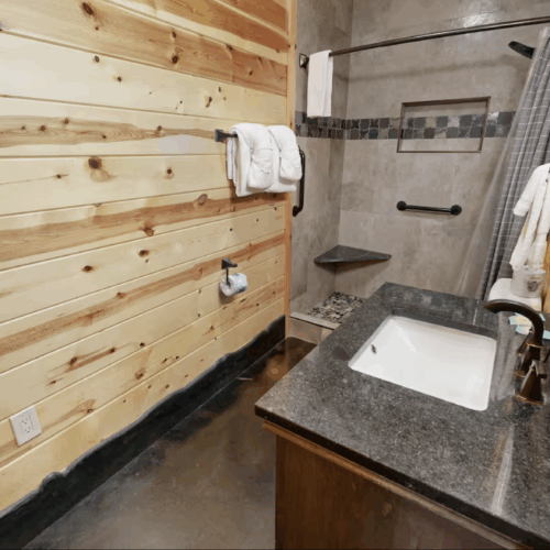 Cozy wooden bathroom with granite countertop and modern fixtures.