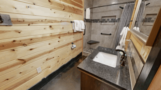 Cozy wooden bathroom with granite countertop and modern fixtures.