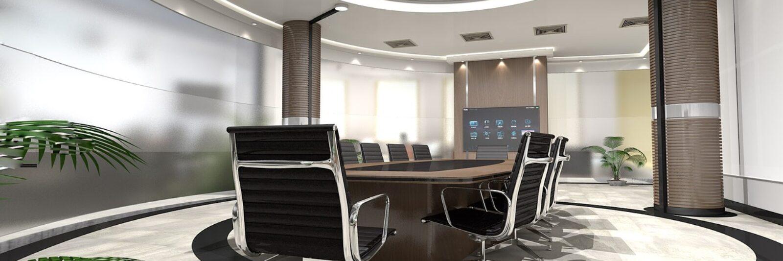 Modern conference room with sleek black chairs and a round table under a circular ceiling light.